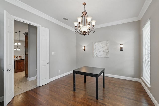 2453 Sir Lovel Ln, Lewisville, TX 75056 - unfurnished dining area with a chandelier, crown molding, dark wood finished floors, and baseboards