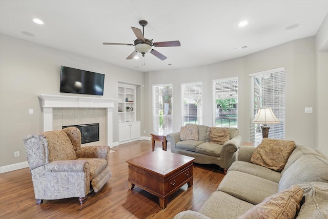 2453 Sir Lovel Ln, Lewisville, TX 75056 - living room with built in shelves, baseboards, a ceiling fan, wood finished floors, and recessed lighting