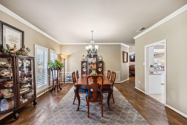 102 Dove Crk, Mckinney, TX 75071 - dining space featuring a chandelier, dark wood-type flooring, crown molding, and baseboards