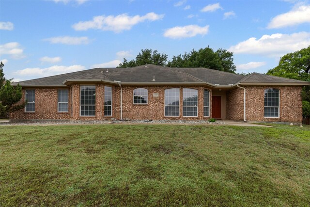 2122 Quail Ridge Dr, Weatherford, TX 76087 - ranch-style home featuring a front yard, brick siding, and a patio area