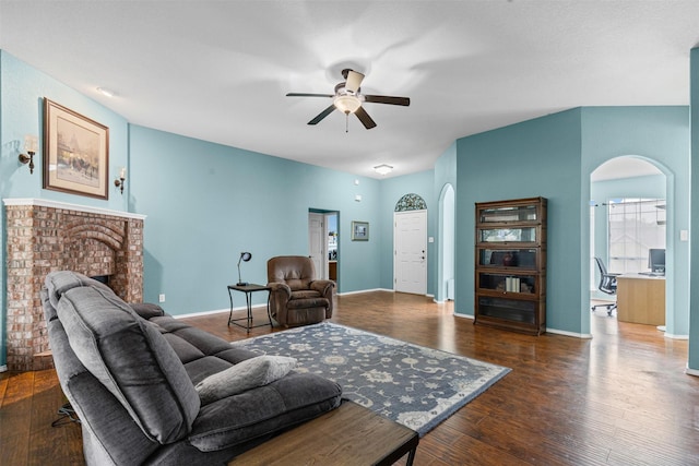 2122 Quail Ridge Dr, Weatherford, TX 76087 - living area with arched walkways, a ceiling fan, a fireplace, and wood finished floors