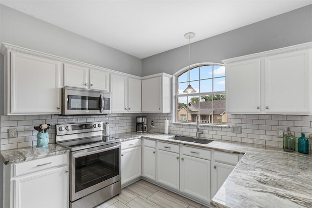2122 Quail Ridge Dr, Weatherford, TX 76087 - kitchen featuring appliances with stainless steel finishes, white cabinets, light stone countertops, and tasteful backsplash