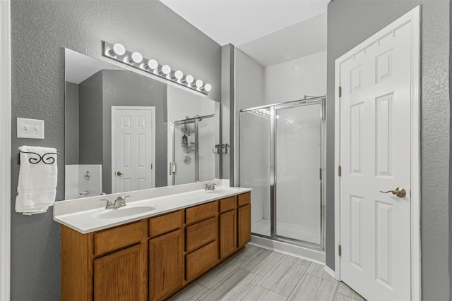 2122 Quail Ridge Dr, Weatherford, TX 76087 - full bath with a stall shower, double vanity, and a textured wall