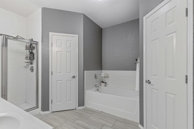 2122 Quail Ridge Dr, Weatherford, TX 76087 - full bathroom with a bath, a stall shower, and a textured wall