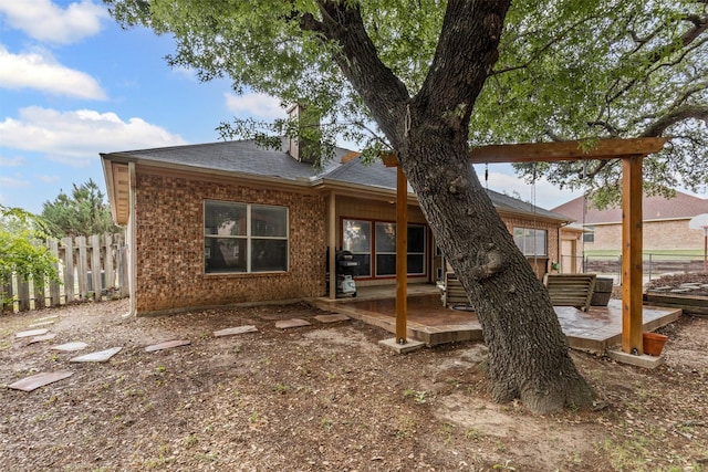 2122 Quail Ridge Dr, Weatherford, TX 76087 - back of house with a patio area, brick siding, and roof with shingles
