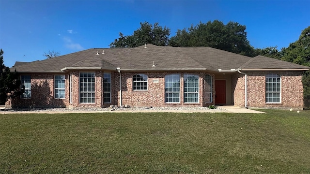 2122 Quail Ridge Dr, Weatherford, TX 76087 - rear view of house featuring a yard, brick siding, and roof with shingles