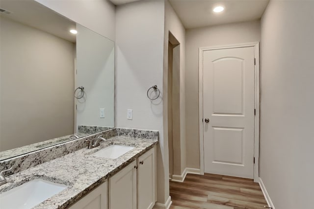 2117 Jeanine Dr, Anna, TX 75409 - bathroom with wood finished floors, double vanity, baseboards, and recessed lighting