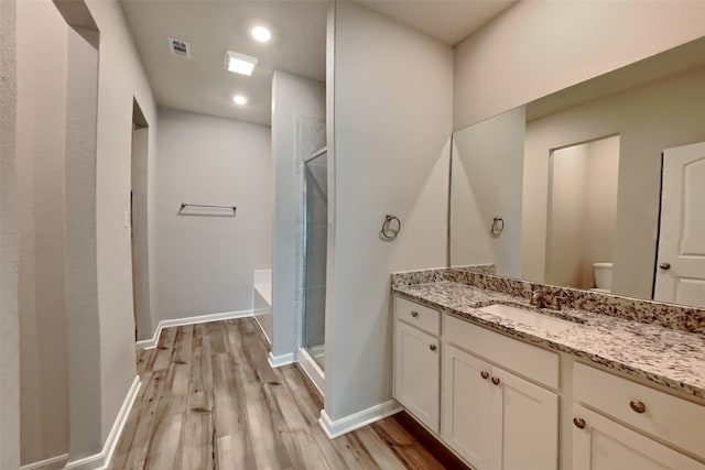 2117 Jeanine Dr, Anna, TX 75409 - full bathroom with vanity, wood finished floors, a stall shower, toilet, and baseboards