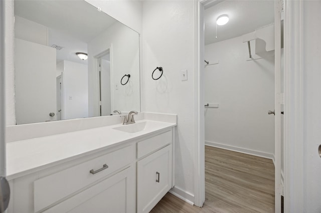 4536 Louisville Dr, Plano, TX 75093 - bathroom featuring vanity, wood finished floors, and baseboards