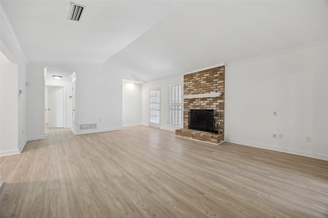 4536 Louisville Dr, Plano, TX 75093 - unfurnished living room featuring light wood-type flooring, baseboards, crown molding, vaulted ceiling, and a brick fireplace