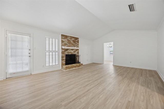 4536 Louisville Dr, Plano, TX 75093 - unfurnished living room with light wood-type flooring, a brick fireplace, a chandelier, lofted ceiling, and baseboards