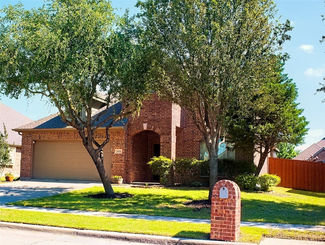 2608 Pine Trail Dr, Little Elm, TX 75068 - view of front of property with brick siding, a garage, concrete driveway, and roof with shingles