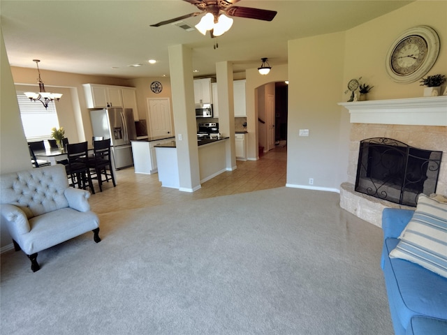 2608 Pine Trail Dr, Little Elm, TX 75068 - living area with ceiling fan, light tile patterned floors, light carpet, a chandelier, and baseboards