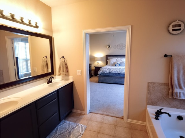 2608 Pine Trail Dr, Little Elm, TX 75068 - bathroom featuring double vanity, connected bathroom, a bath, tile patterned floors, and baseboards