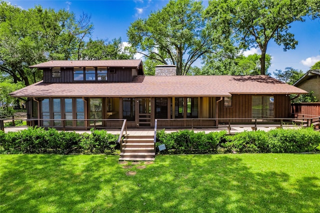 188 Enchanted Dr, Enchanted Oaks, TX 75156 - view of front of property with a chimney, a front yard, stairs, board and batten siding, and a shingled roof