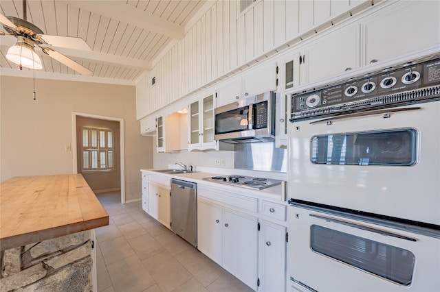188 Enchanted Dr, Enchanted Oaks, TX 75156 - kitchen with stainless steel appliances, a sink, a ceiling fan, light countertops, and white cabinetry
