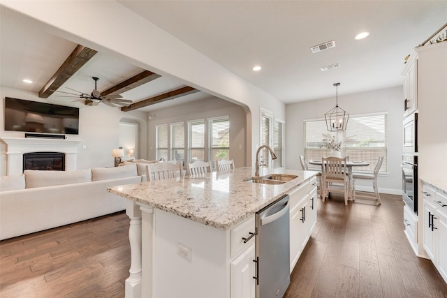 10321 Colina Dr, Fort Worth, TX 76126 - kitchen featuring a sink, stainless steel appliances, a ceiling fan, beam ceiling, and a kitchen island with sink