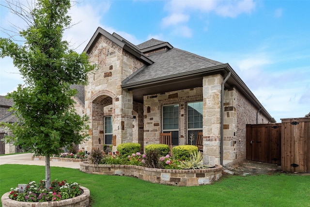 10321 Colina Dr, Fort Worth, TX 76126 - french country inspired facade featuring roof with shingles, stone siding, and a gate
