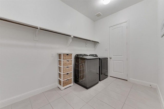 10321 Colina Dr, Fort Worth, TX 76126 - laundry room featuring washing machine and clothes dryer, baseboards, and light tile patterned floors