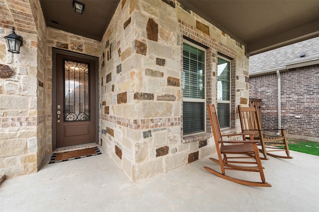 10321 Colina Dr, Fort Worth, TX 76126 - view of exterior entry with a porch and stone siding