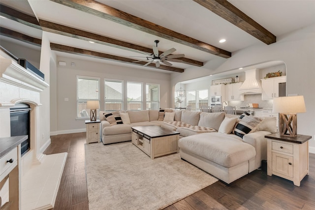 10321 Colina Dr, Fort Worth, TX 76126 - living area featuring a ceiling fan, dark wood-type flooring, a tile fireplace, baseboards, and beamed ceiling