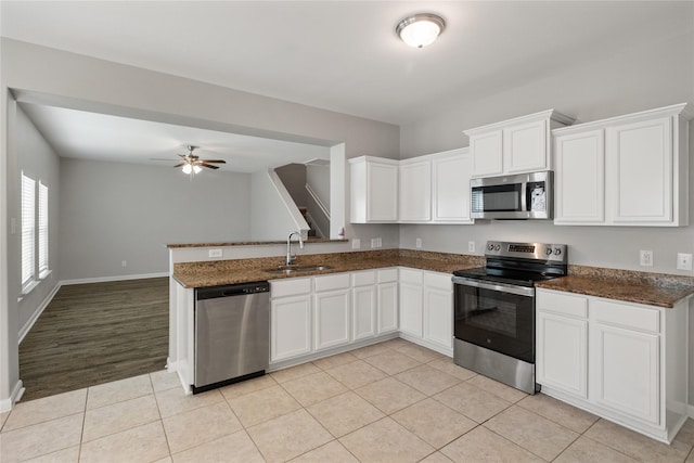 134 Kennedy Dr, Venus, TX 76084 - kitchen with appliances with stainless steel finishes, a sink, white cabinets, light tile patterned flooring, and ceiling fan