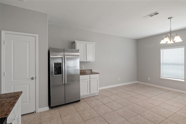 134 Kennedy Dr, Venus, TX 76084 - kitchen featuring stainless steel refrigerator with ice dispenser, a chandelier, dark stone counters, white cabinets, and baseboards