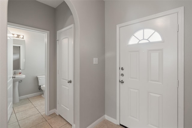 134 Kennedy Dr, Venus, TX 76084 - foyer featuring arched walkways, light tile patterned flooring, and baseboards