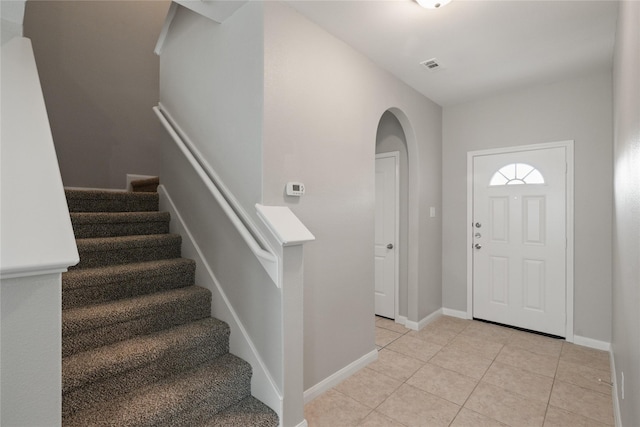 134 Kennedy Dr, Venus, TX 76084 - foyer featuring arched walkways, stairs, light tile patterned floors, and baseboards