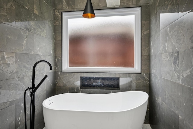 10004 Concord Dr, Frisco, TX 75035 - full bath featuring tile walls, healthy amount of natural light, and a freestanding tub