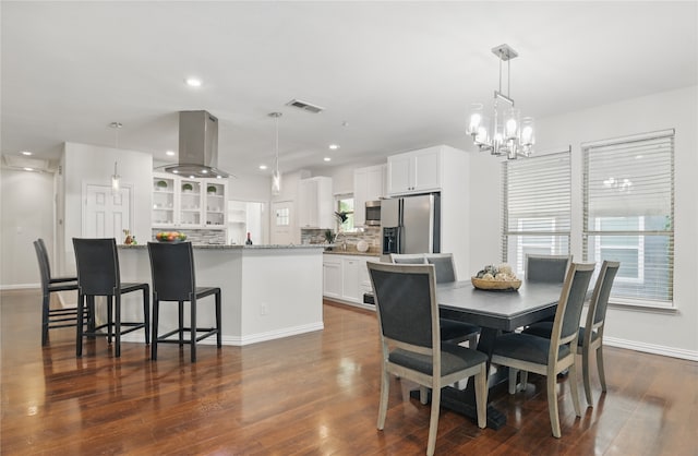634 N Tyler St, Dallas, TX 75208 - dining space with baseboards, dark wood-type flooring, recessed lighting, and a chandelier