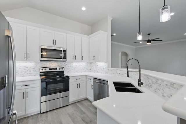 130 N Point Dr, Krum, TX 76249 - kitchen with stainless steel appliances, a sink, light countertops, light wood-style floors, and tasteful backsplash