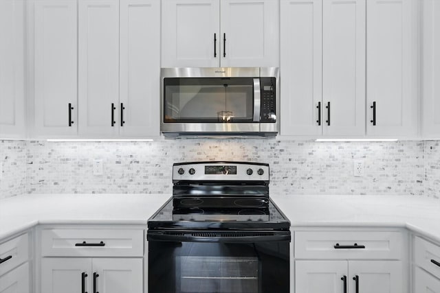 130 N Point Dr, Krum, TX 76249 - kitchen with stainless steel microwave, black range with electric stovetop, light countertops, white cabinetry, and backsplash