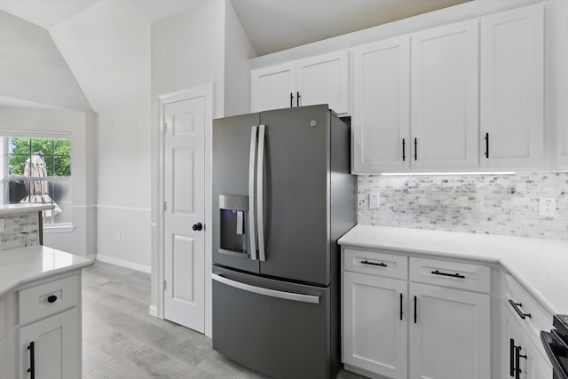 130 N Point Dr, Krum, TX 76249 - kitchen with stainless steel fridge with ice dispenser, decorative backsplash, vaulted ceiling, white cabinets, and light countertops