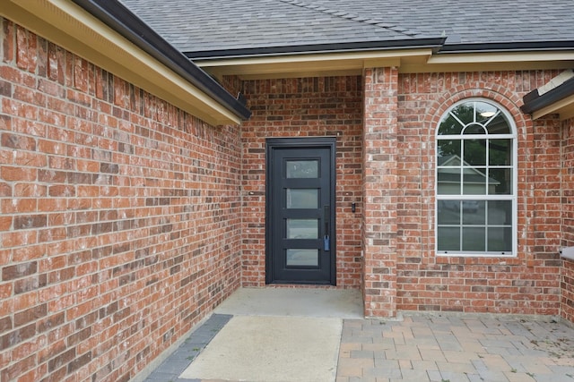 130 N Point Dr, Krum, TX 76249 - property entrance featuring a shingled roof and brick siding
