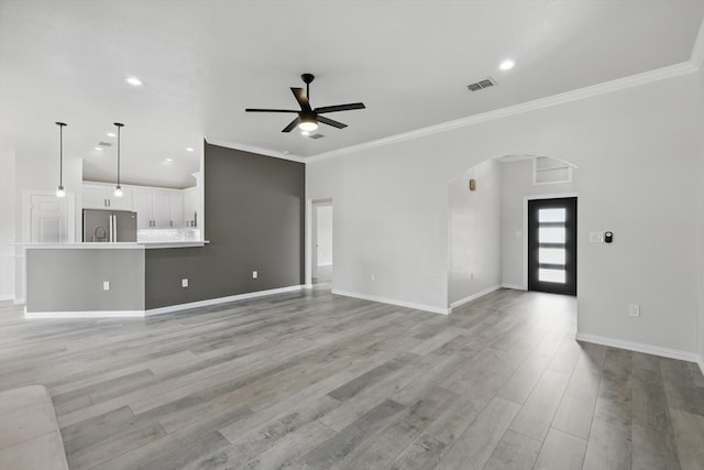 130 N Point Dr, Krum, TX 76249 - unfurnished living room with arched walkways, a ceiling fan, ornamental molding, recessed lighting, and light wood-style floors