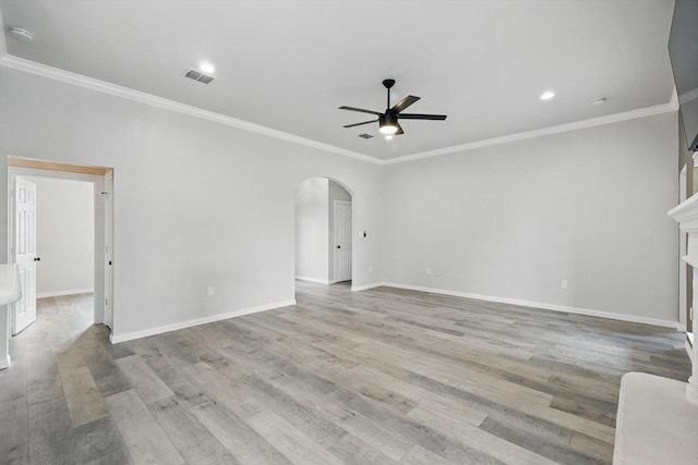 130 N Point Dr, Krum, TX 76249 - unfurnished living room with a ceiling fan, arched walkways, baseboards, crown molding, and light wood-style floors