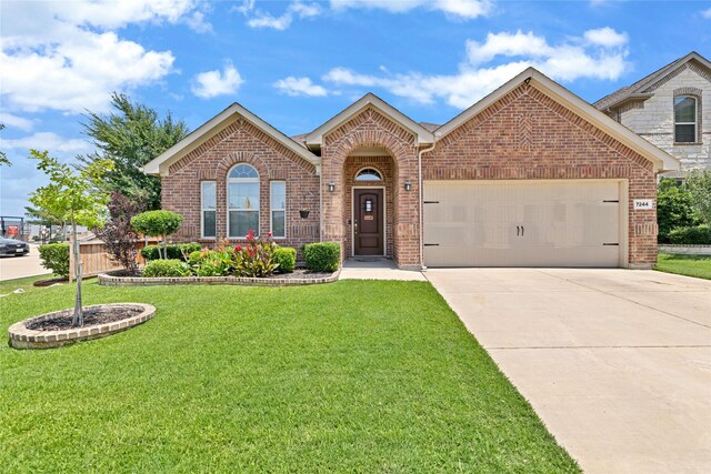 7244 Montosa Trl, Fort Worth, TX 76131 - view of front of property with brick siding, a front yard, and an attached garage