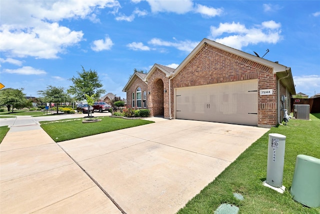 7244 Montosa Trl, Fort Worth, TX 76131 - view of front of home with brick siding, an attached garage, a front yard, and concrete driveway