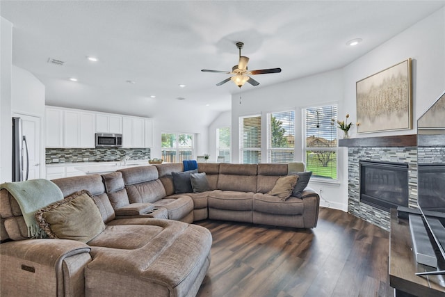 7244 Montosa Trl, Fort Worth, TX 76131 - living area with dark wood-style flooring, a ceiling fan, a stone fireplace, recessed lighting, and vaulted ceiling