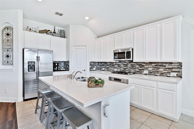 7244 Montosa Trl, Fort Worth, TX 76131 - kitchen with stainless steel appliances, light tile patterned flooring, decorative backsplash, lofted ceiling, and an island with sink