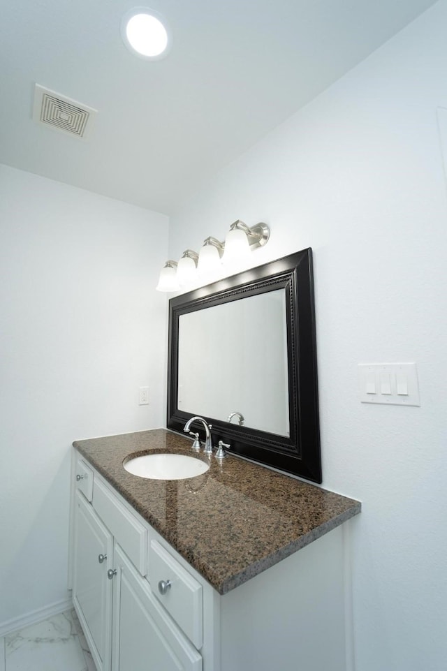 704 Vine St, Euless, TX 76040 - bathroom with vanity, marble look tiles, and baseboards