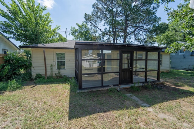 704 Vine St, Euless, TX 76040 - back of house featuring a sunroom and a lawn