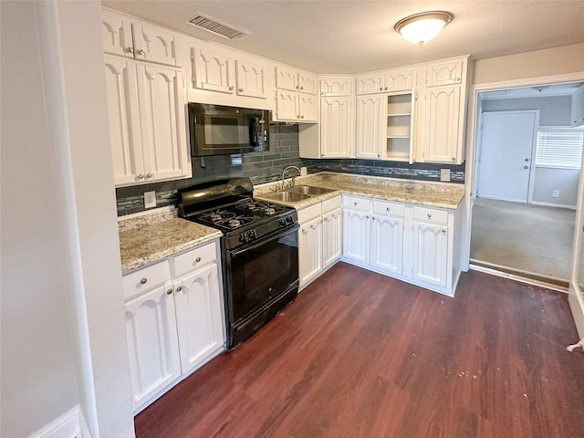 5729 Blackmore Ave, Fort Worth, TX 76107 - kitchen featuring black appliances, a sink, dark wood-style flooring, decorative backsplash, and white cabinetry