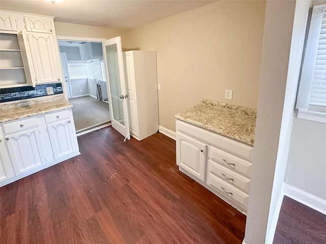 5729 Blackmore Ave, Fort Worth, TX 76107 - kitchen with dark wood finished floors, white cabinetry, baseboards, and light stone countertops