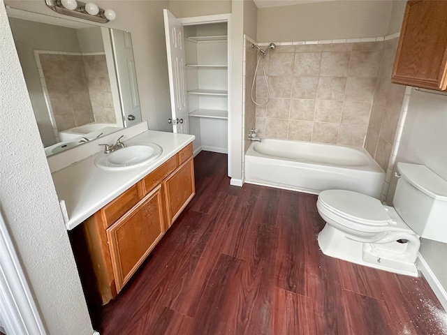 5729 Blackmore Ave, Fort Worth, TX 76107 - bathroom featuring toilet, wood finished floors, washtub / shower combination, and vanity