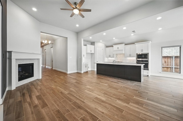 1419 Misty Pasture Way, Mansfield, TX 76063 - unfurnished living room featuring a ceiling fan, baseboards, wood finished floors, a chandelier, and recessed lighting