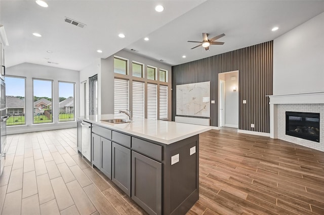 1419 Misty Pasture Way, Mansfield, TX 76063 - kitchen with open floor plan, a sink, an accent wall, gray cabinetry, and healthy amount of natural light