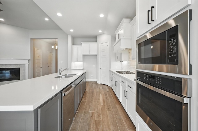 1419 Misty Pasture Way, Mansfield, TX 76063 - kitchen with appliances with stainless steel finishes, a sink, wood finished floors, light countertops, and recessed lighting