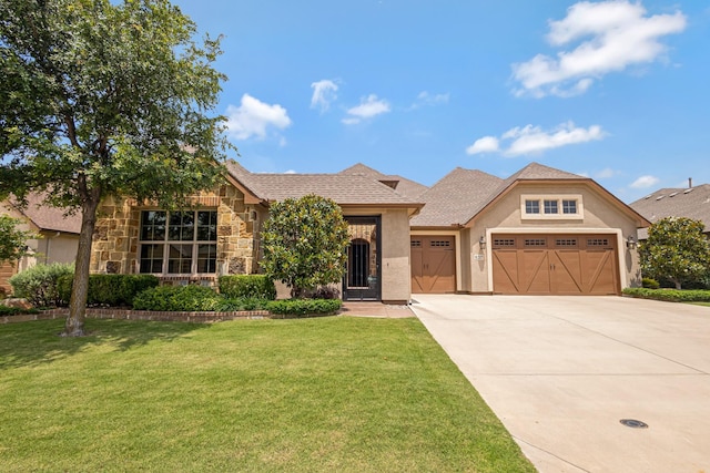 8217 American Way, Denton, TX 76207 - view of front of house featuring an attached garage, a front lawn, concrete driveway, stucco siding, and stone siding
